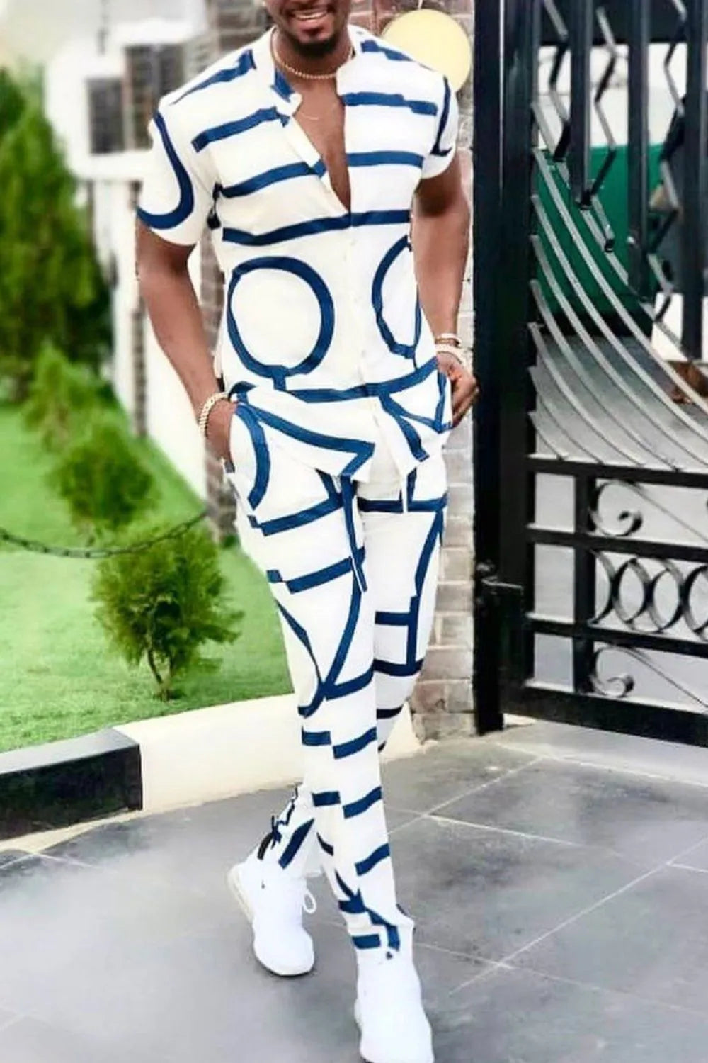 Men's full size geo print short sleeve top and pants set in white with navy geometric patterns, slightly stretchy, polyester and cotton blend.