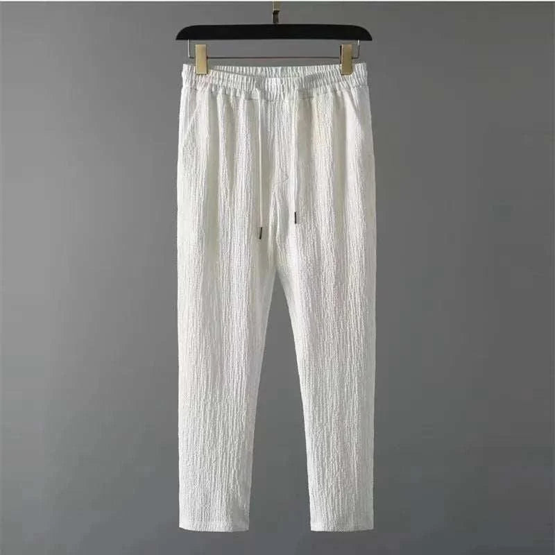 White pants from the Summer Men Vacation set with drawstring closure and high-quality polyester material.