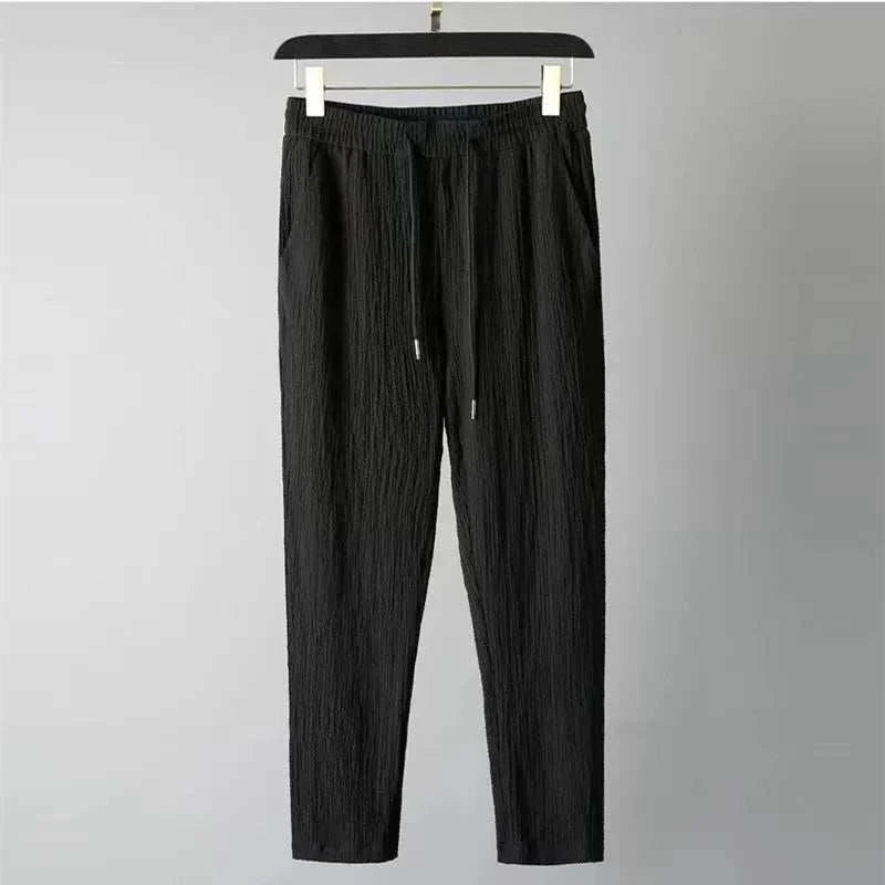Men's black drawstring pants from Summer Men Vacation set on hanger.