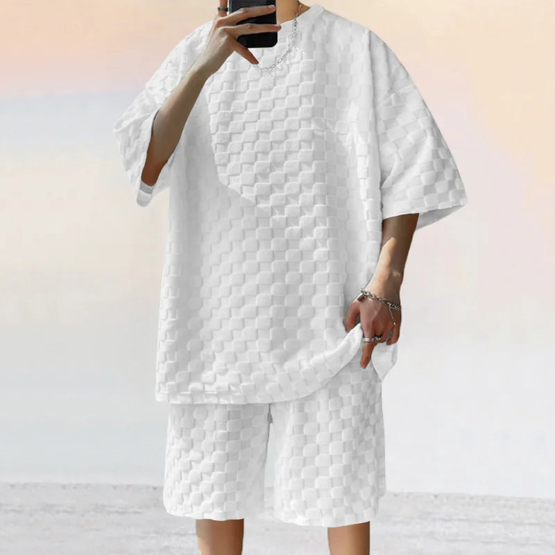 Men leisure oversized two-piece shorts set in white with textured fabric, featuring O-neck collar and drawstring closure.