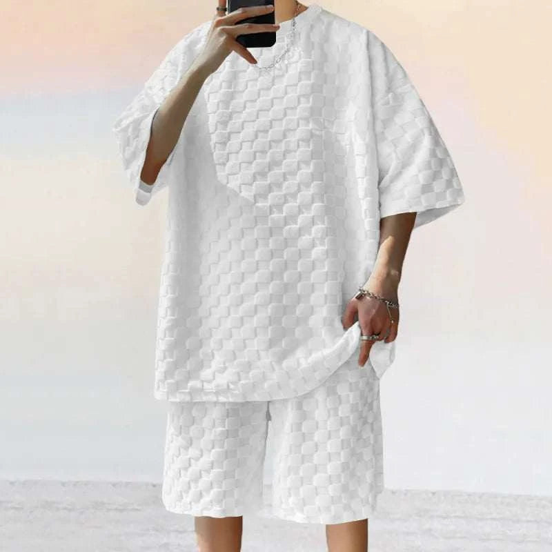 Men leisure oversized two-piece shorts set in white with textured fabric, featuring O-neck collar and drawstring closure.