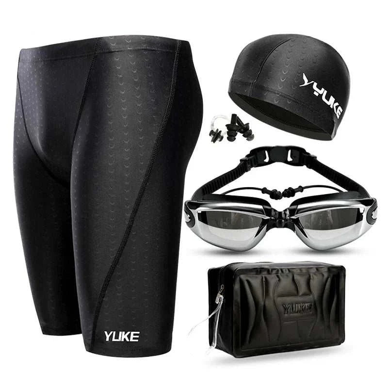 Men's swim shorts set with waterproof goggles, ear-plug cap, and shark skin design.
