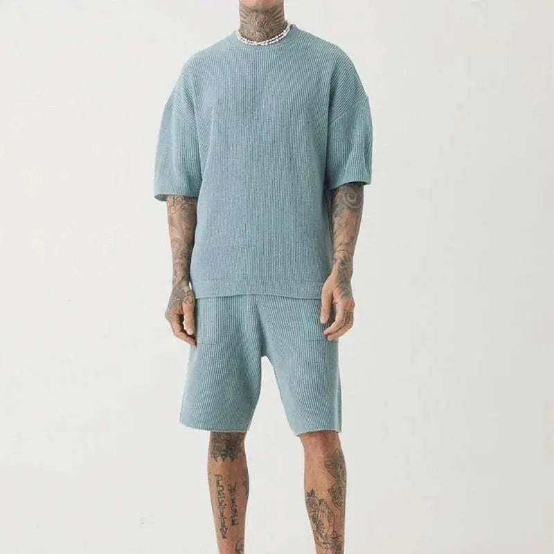 Beach casual street wear men's outfit set with short sleeves and elastic waist shorts.