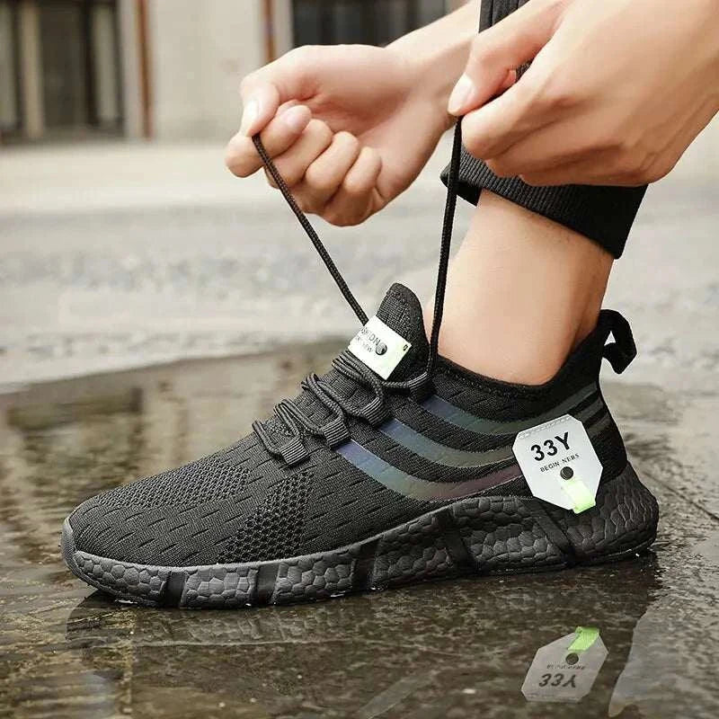 Men's black casual sport shoes with breathable mesh, lightweight design, and lace-up closure.