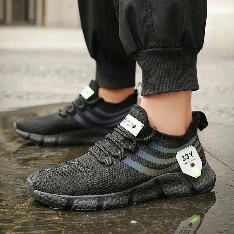 Men's black casual sport shoes with breathable mesh design, lightweight and anti-odor features, suitable for running and walking.