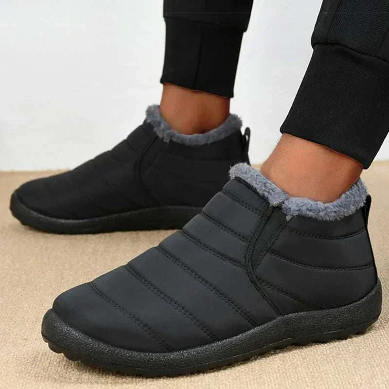 Men's waterproof ankle boots with plush lining, slip-on design, and round toe shape for warmth and comfort in winter.