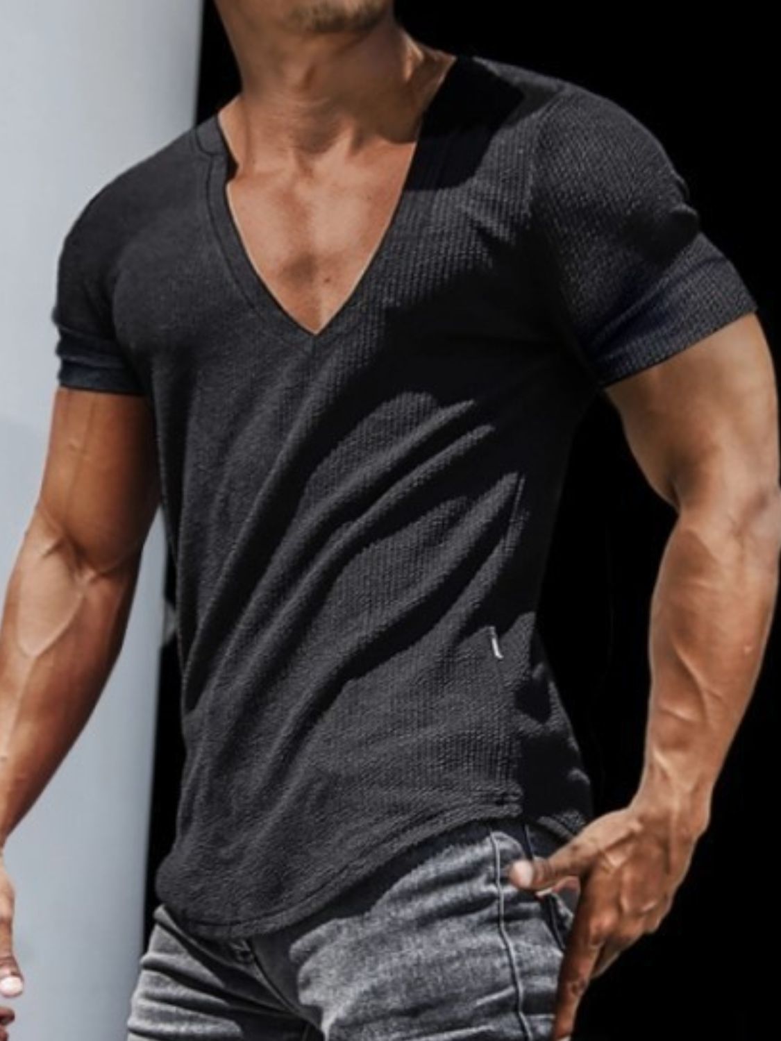 Men's full size notched short sleeve t-shirt in black, stretchy polyester-cotton blend.