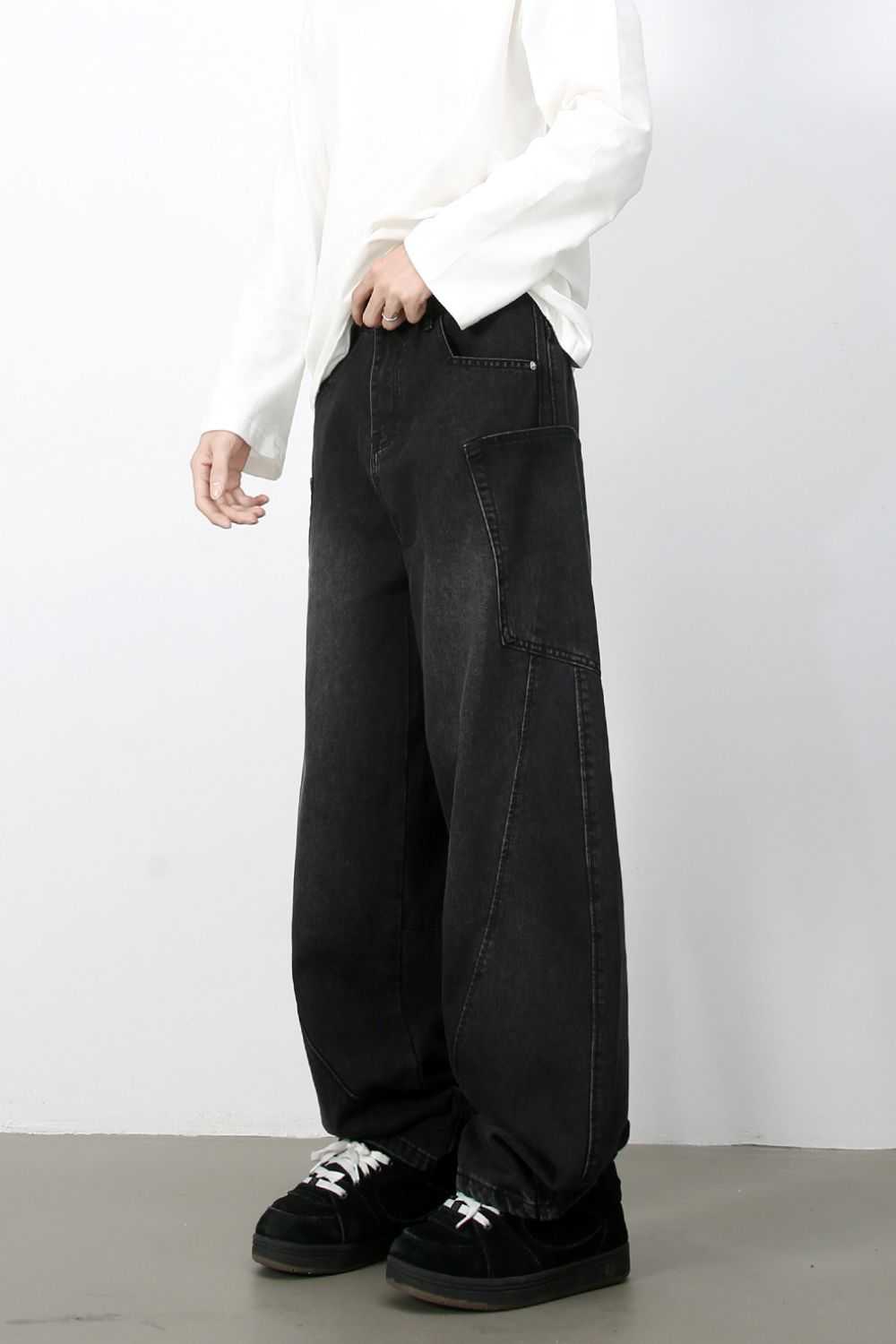 Men's wide leg jeans with pockets, black, styled with black shoes and white shirt.