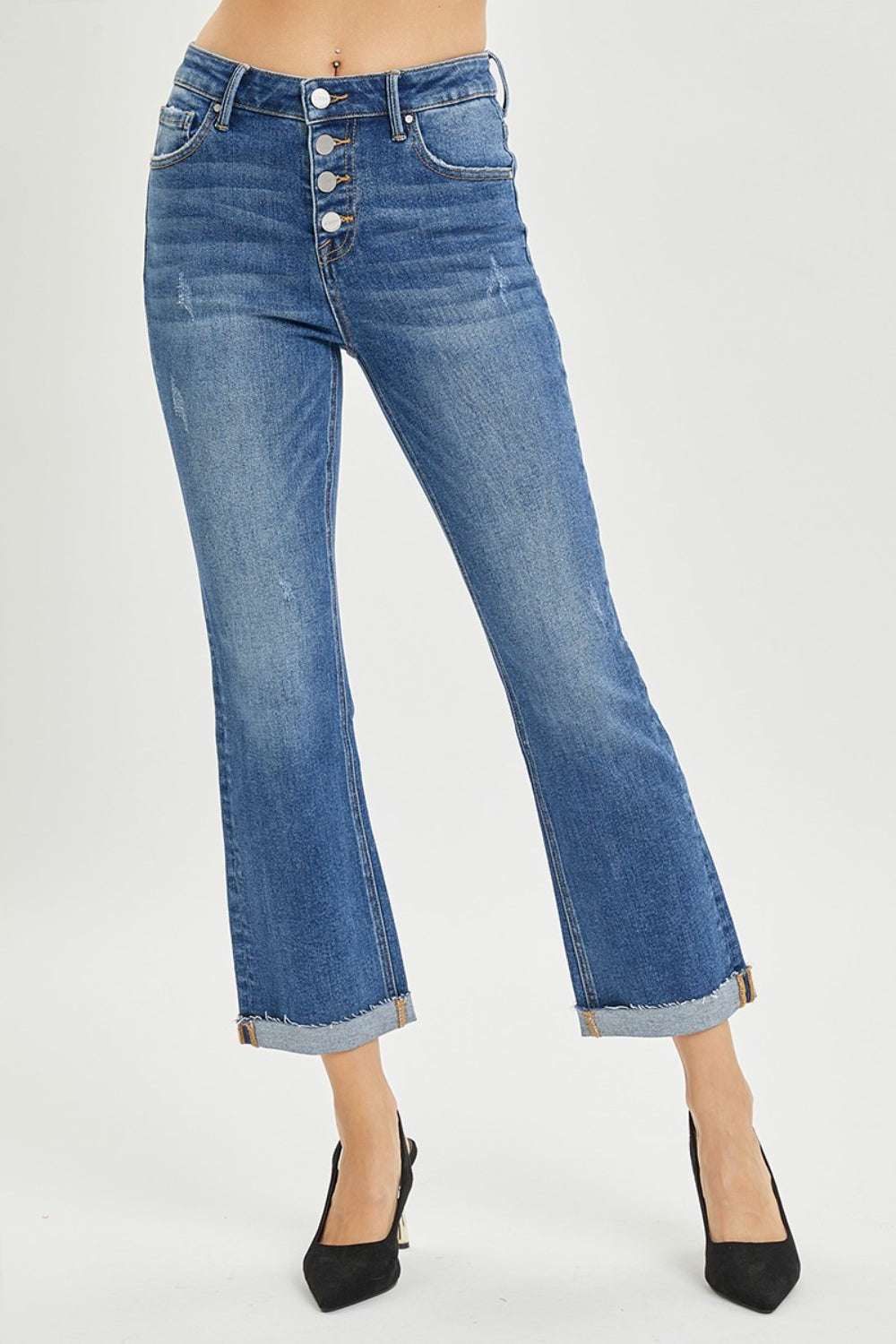Full size button fly cropped bootcut jeans in blue denim on model showing front view.