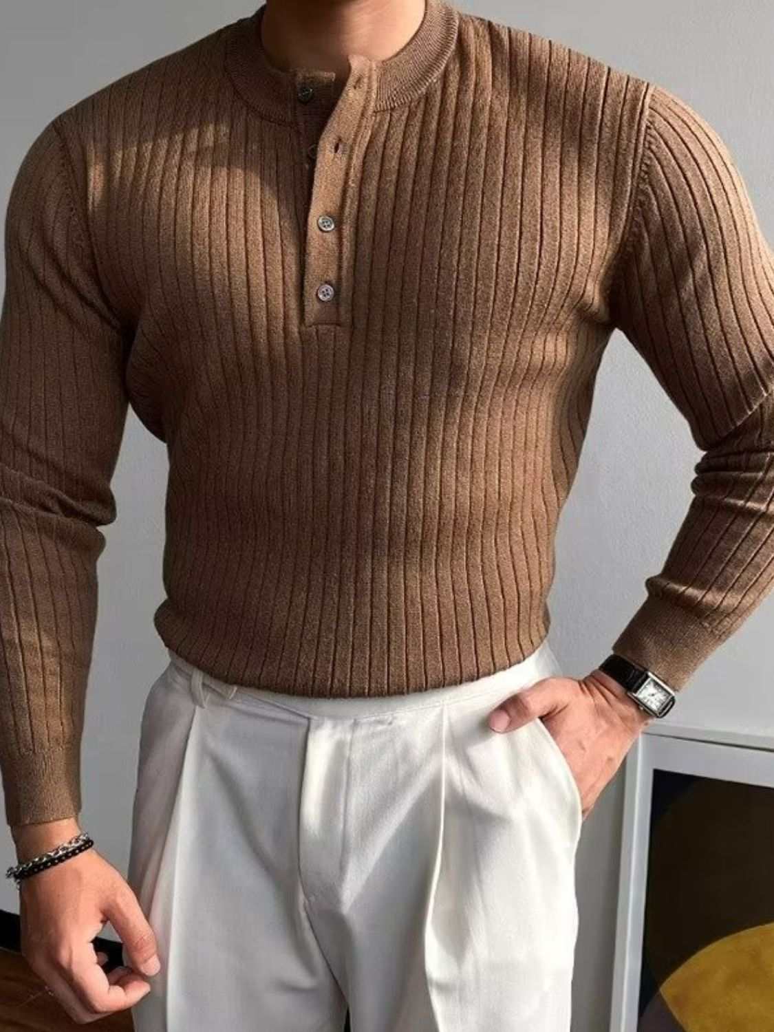 Ribbed long sleeve men's knit top with button detail, stretchy cotton blend.