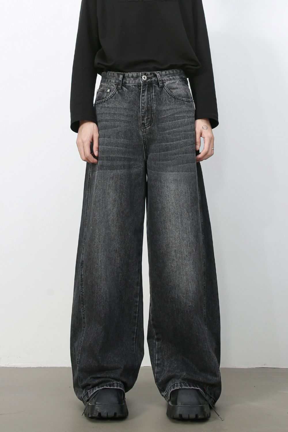 Men's wide leg jeans in dark wash denim with cat's whisker detailing, non-stretch fabric.