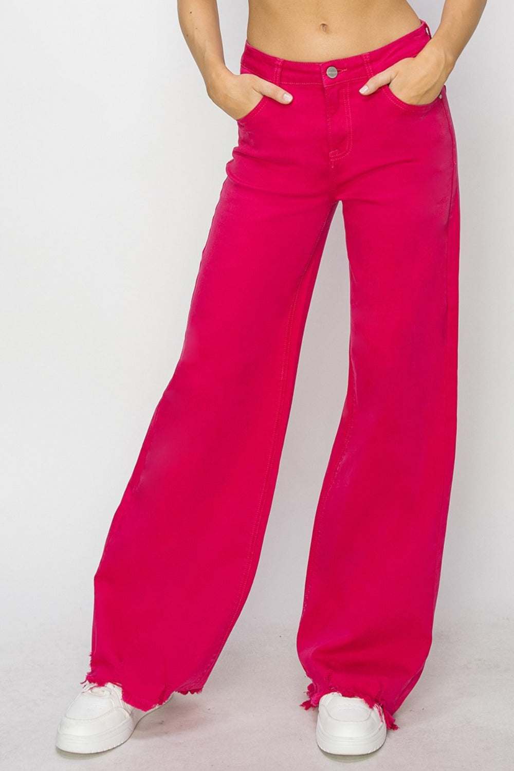 High rise wide leg jeans with raw hem in vibrant pink color.