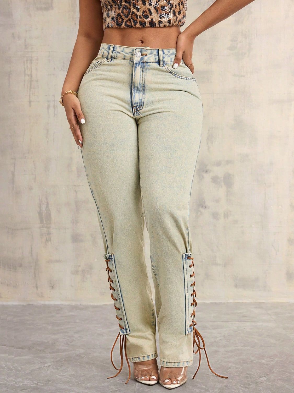 Lace-Up High Rise Jeans with buttoned front and pocket details.