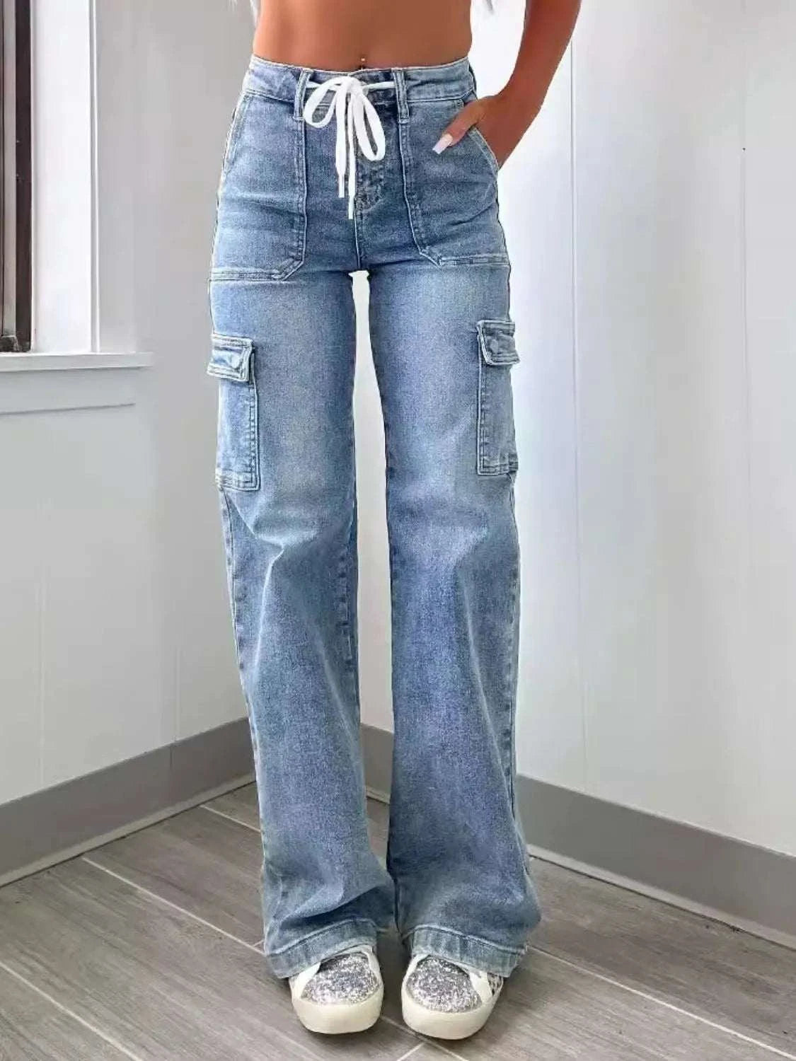 Washed jeans with pockets and tie detail, shown on model.