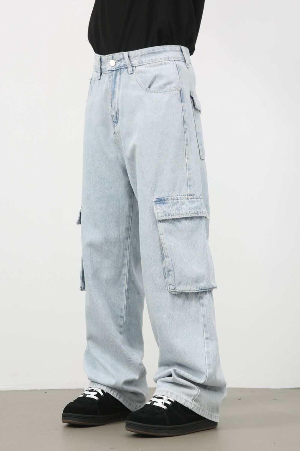 Men's wide leg jeans with cargo pockets in light blue denim.
