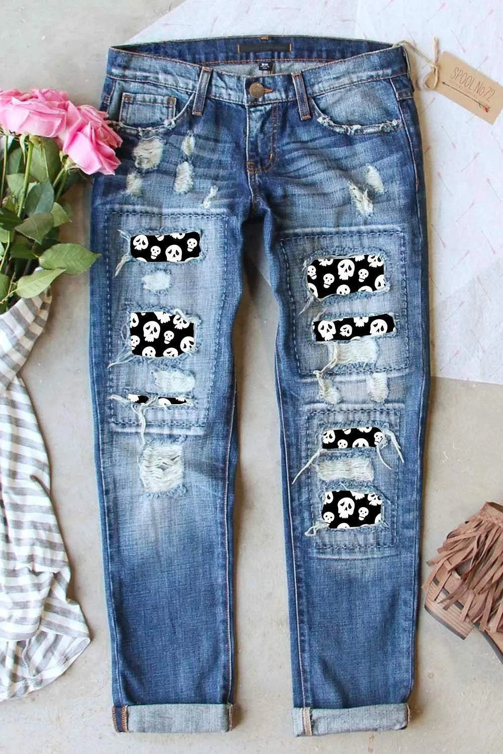 Distressed jeans with skeleton pattern and pockets.