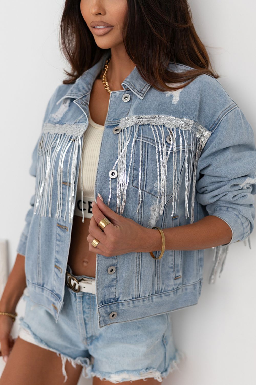 Sequin fringe trim distressed button-up denim jacket with no stretch.