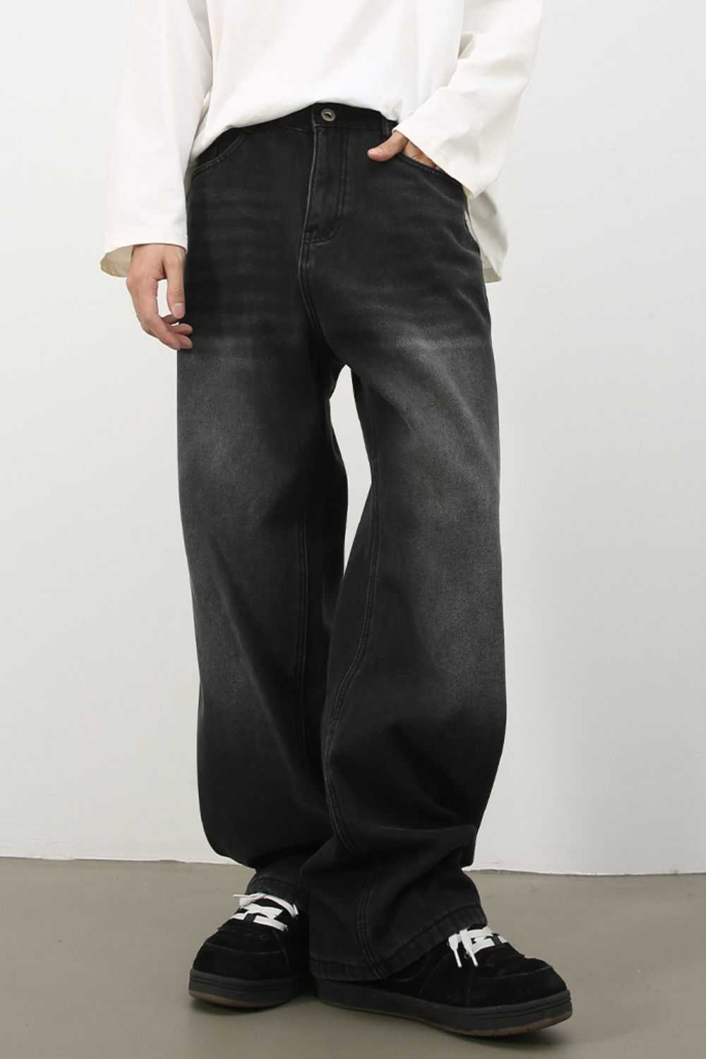 Men's wide leg jeans in washed black, non-stretch fabric.