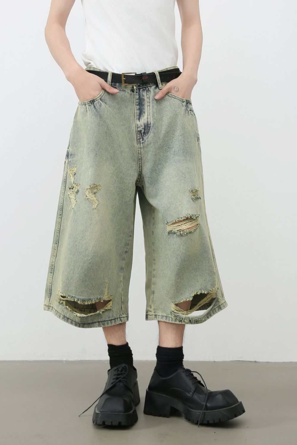 Men's distressed loose denim shorts with ripped details, basic style.