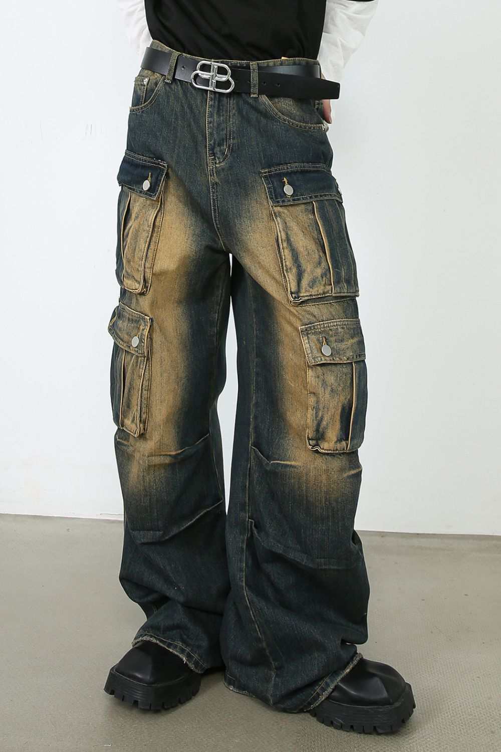 Men's washed wide leg jeans with multiple pockets and faded style.