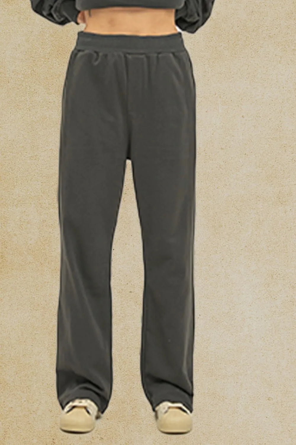 Men's elastic waist pants with pockets in dark color, basic style.