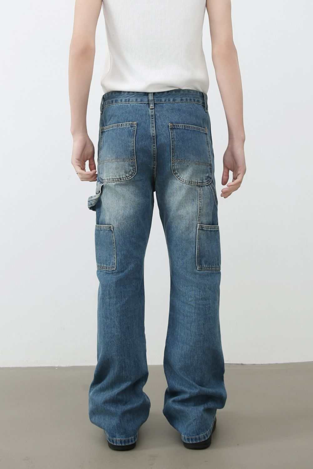 Men's distressed baggy jeans with pockets and blue washed finish.