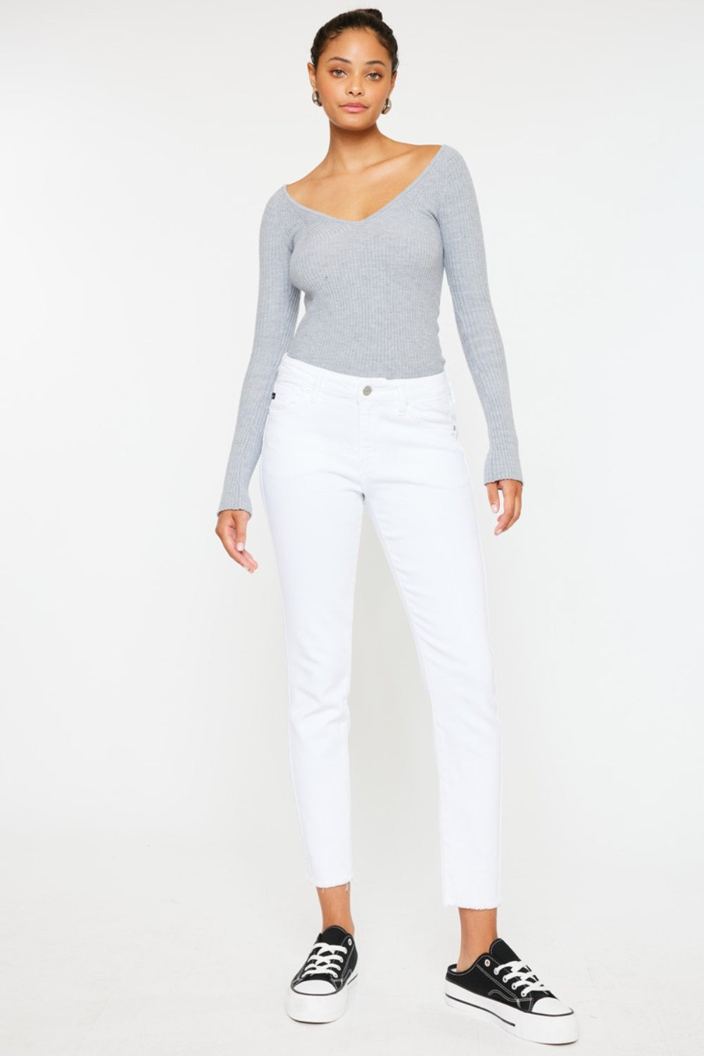 Kancan Mid Rise Ankle Skinny Jeans with a sleek fit and moderate stretch, styled with sneakers.