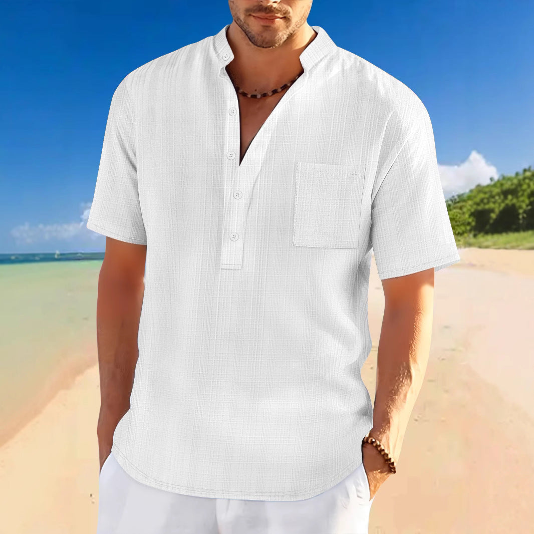Men's full size half button short sleeve white polo on beach background.