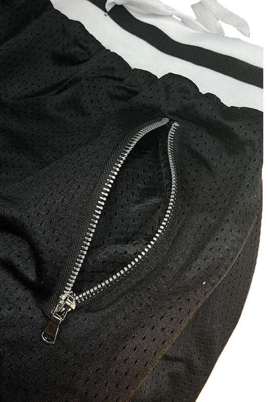 Solid basketball shorts with striped band, mesh fabric, and zippered pocket.