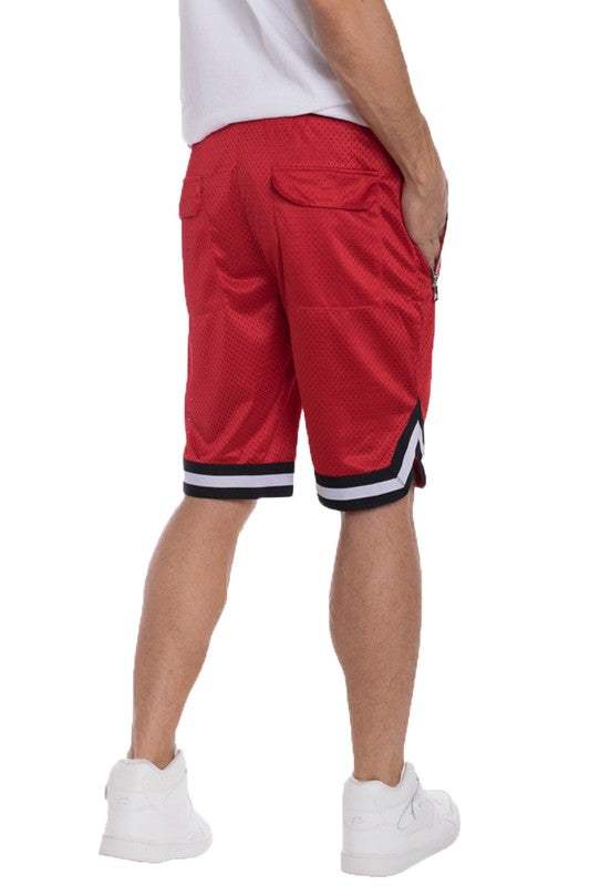 Red basketball shorts with striped waistband and hem, elastic waistband, zippered side pockets, and back pockets.