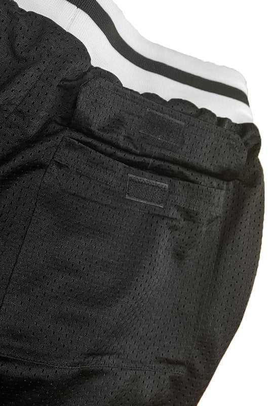 Black basketball shorts with striped waistband, mesh fabric, and back pockets.