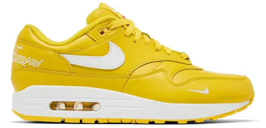 Supreme x Air Max 1 '87 SP 'Speed Yellow' sneakers with striking yellow leather, white snakeskin-textured Swoosh, and Supreme branding.