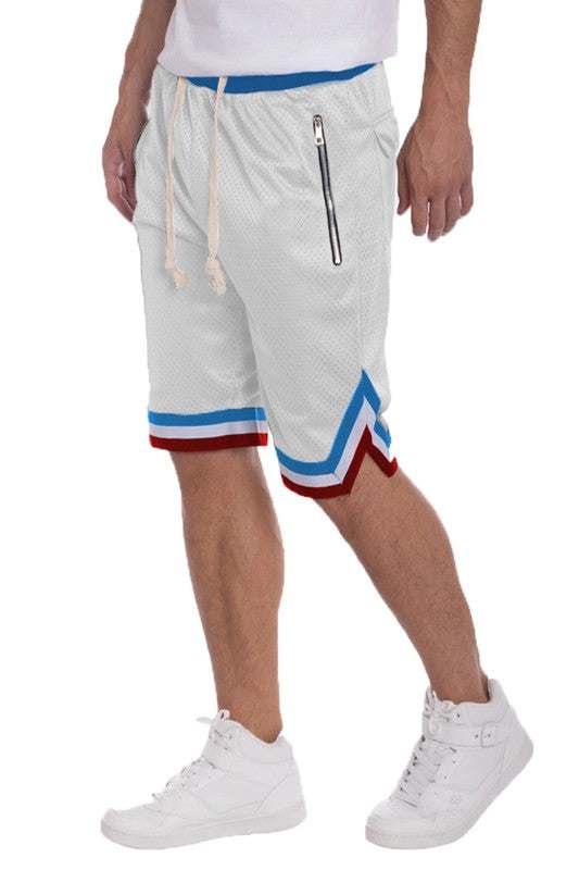 Men's solid basketball shorts with striped band, featuring elastic waistband, drawstring, mesh fabric, side zippered pockets, and contrast stripes on waistband and hem.