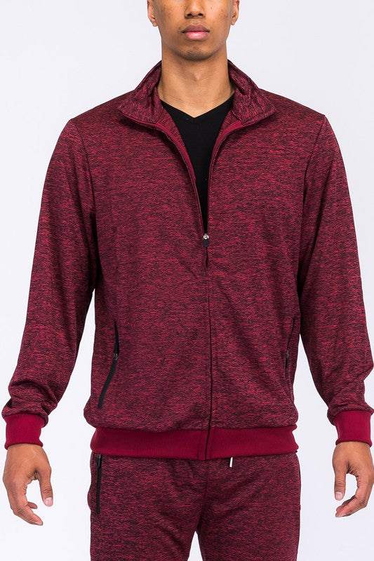 MARBLED TRACK JACKET with zipper pockets and elastic waist in burgundy, crafted from polyester and spandex for comfort and style.