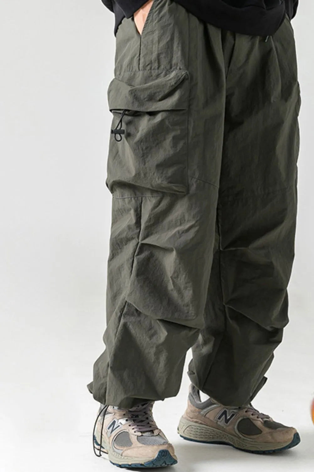 Men's plus size elastic waist pants with pockets, nylon material, casual style.