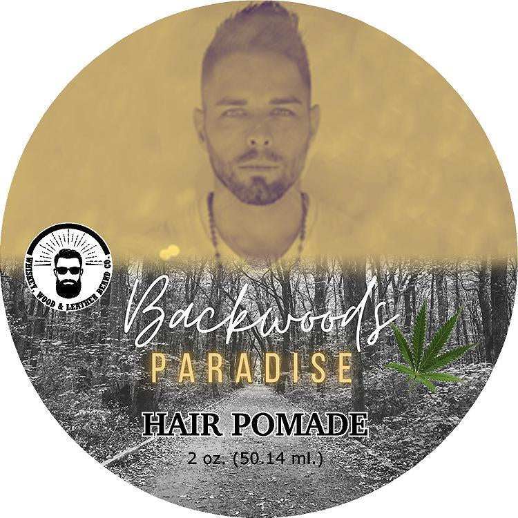 Backwoods Paradise Hair Pomade label with forest imagery and product name.