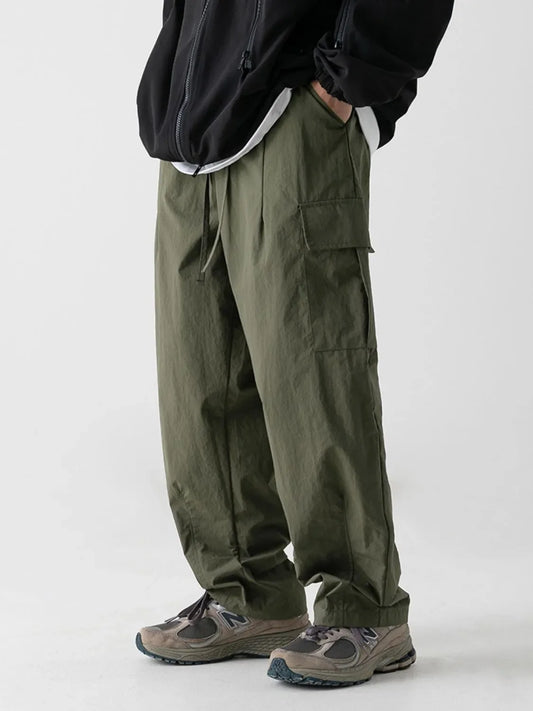 Men's plus size wide leg cargo pants in olive green with basic style and large pockets.