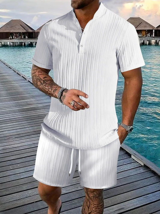 Men's full-size white button detail short sleeve top and shorts set near waterfront.