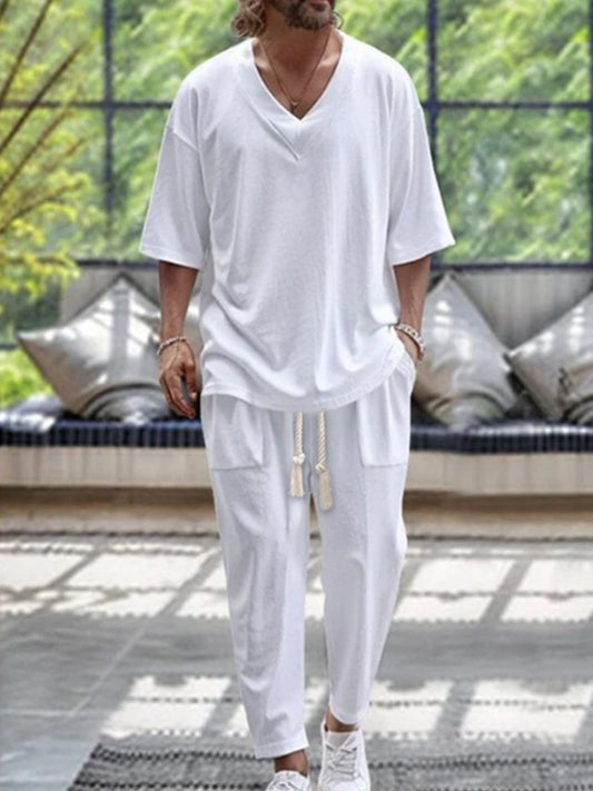 Men's plus size V-neck half sleeve top and pants set in white.