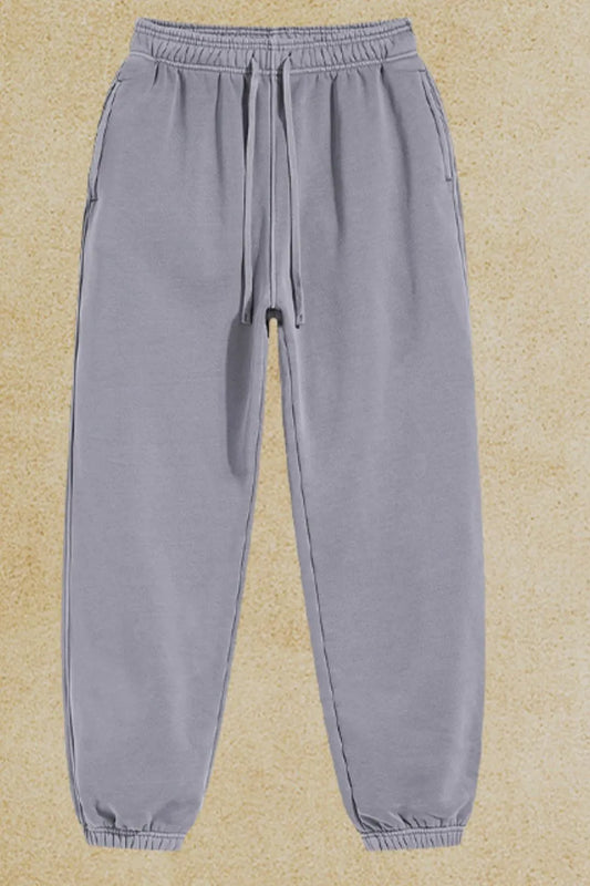 Men's drawstring joggers with pockets made of cotton-polyester blend.