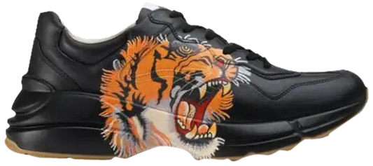 Gucci Rhyton Leather 'Tiger Print' sneakers with bold orange tiger graphic on black leather.