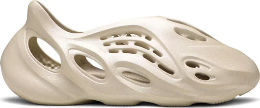 adidas Yeezy Foam RNNR "Sand" with sculpted design and oval cut-outs in monochromatic sand color.