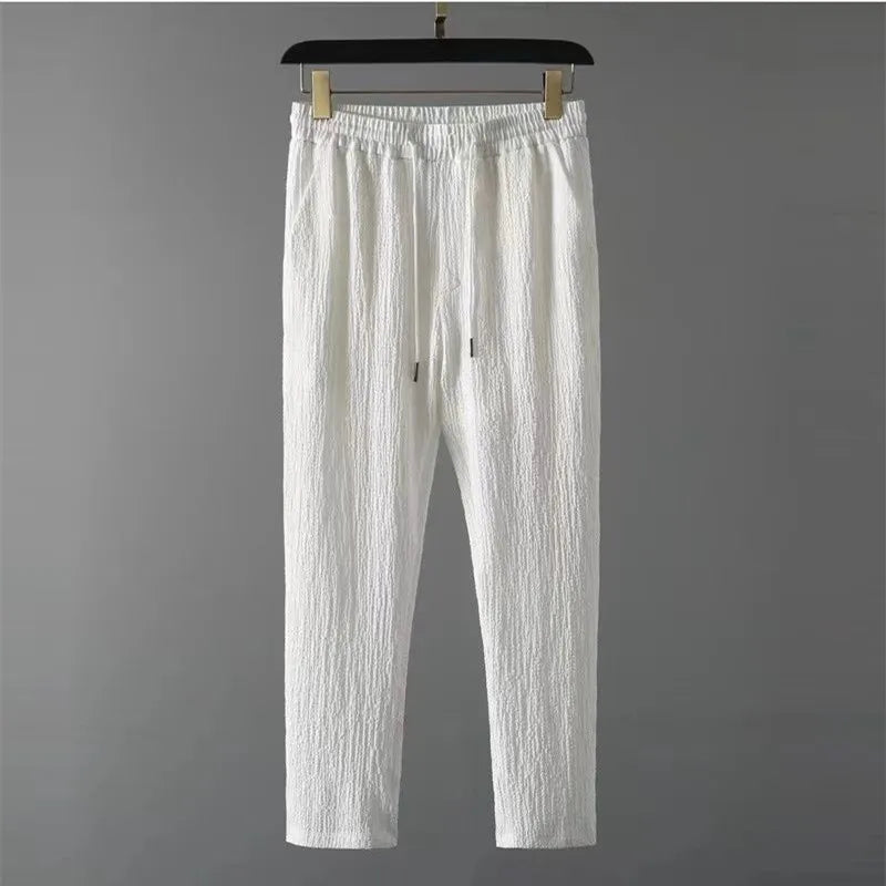 White pants from the Summer Men Vacation set with drawstring closure and high-quality polyester material.