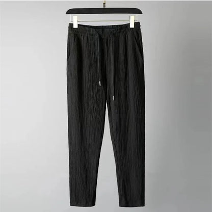 Men's black drawstring pants from Summer Men Vacation set on hanger.