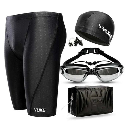 Men's swim shorts set with waterproof goggles, ear-plug cap, and shark skin design.
