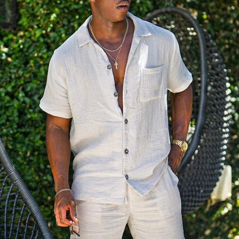 Men's beach shorts set with short sleeves, solid pattern, and drawstring closure. Made of high-quality cotton, perfect for stylish casual occasions in spring and summer.