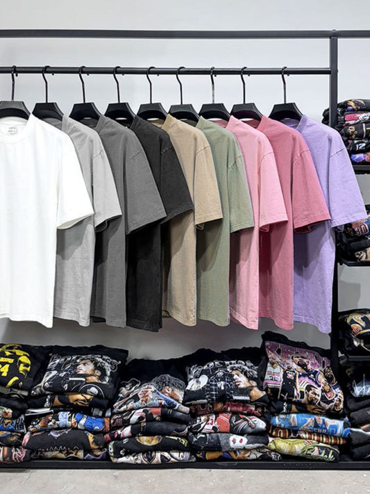 Men's full size round neck washed T-shirts in various colors hanging on a rack.