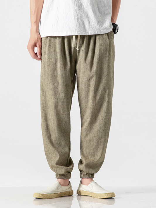 Stylish men's drawstring linen blend harem pants in beige, offering comfort and casual fashion.