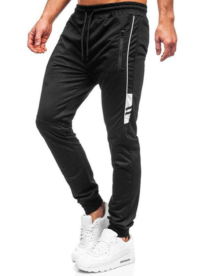 Men's comfort-fit sports trousers in black with white detailing, featuring slant pockets and elastic cuffs, ideal for casual fashion.