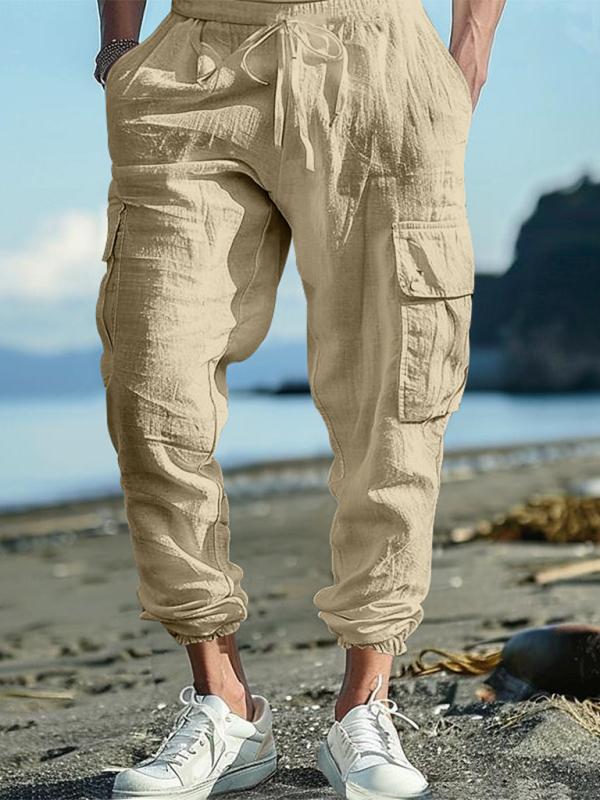 Relaxed fit solid color trousers with drawstrings, multi-pocket design, and casual cuffs.